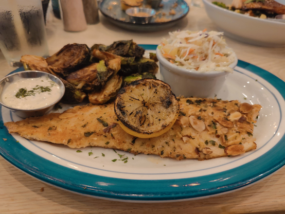 Trout almondine with miso-glazed brussel sprouts and pineapple coleslaw