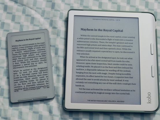 Both devices are displaying text from the Water Magician Arc 1 vol 4