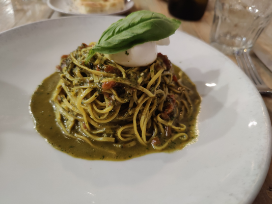 Pesto pasta with sun-dried tomatoes and burrata cheese