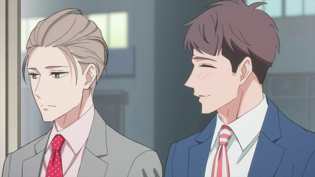 The two main characters wearing suits